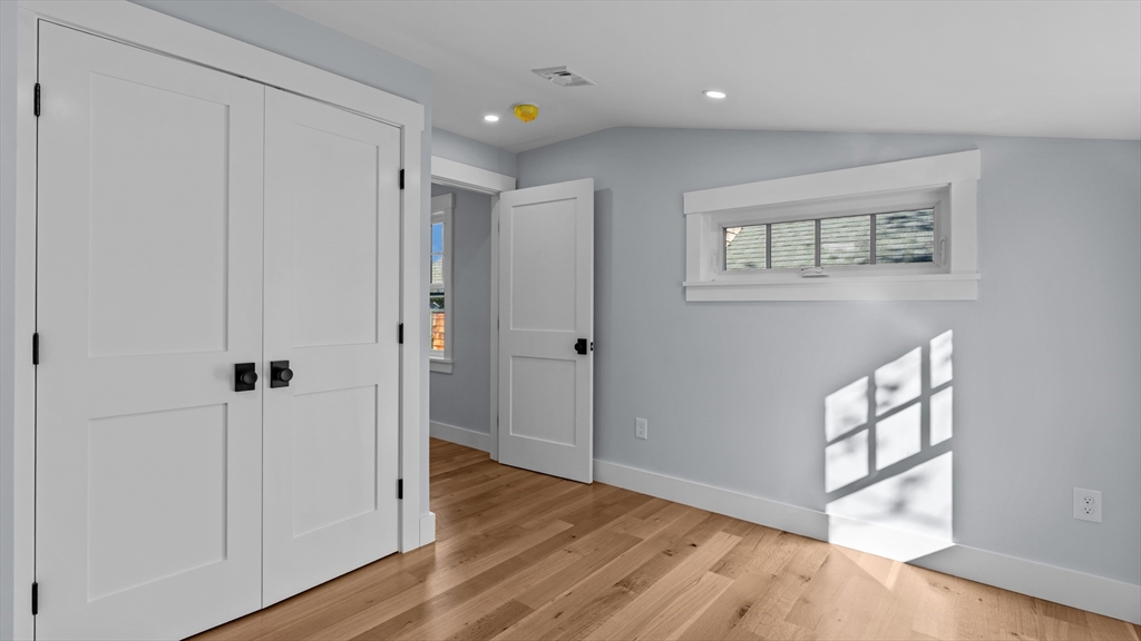 39 Connection Street Newport, RI 02840 - Photo 7 of 40 a view of a hallway with wooden floor and closet area