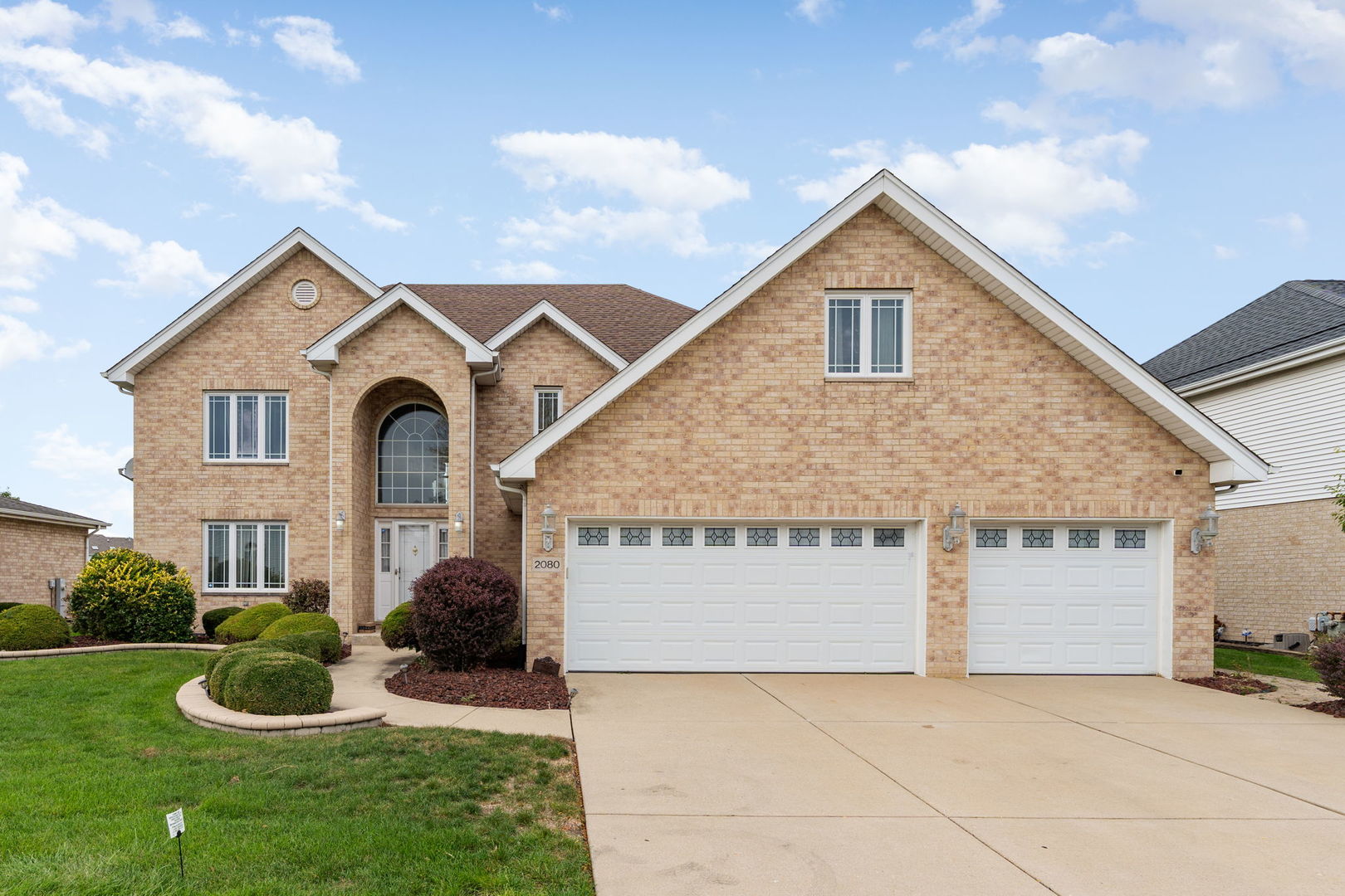 a front view of a house with a yard and garage