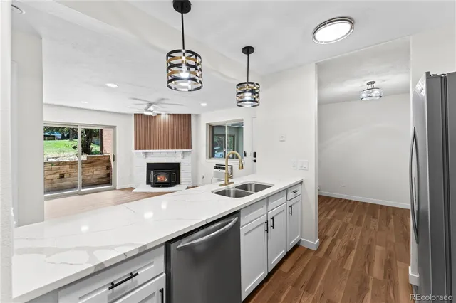 a kitchen with a sink and a fireplace