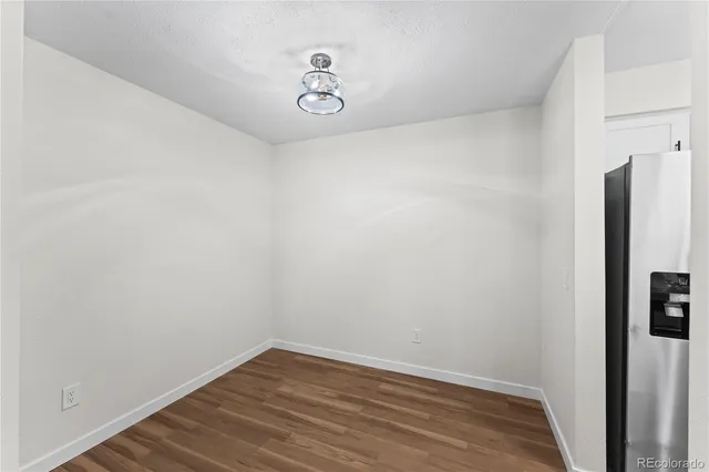 a view of a room with wooden floor