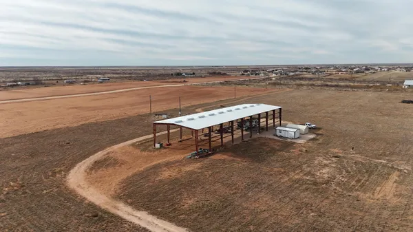 a view of a terrace with lawn chairs