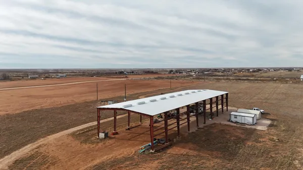 a view of a patio with a dining table and chairs with wooden floor