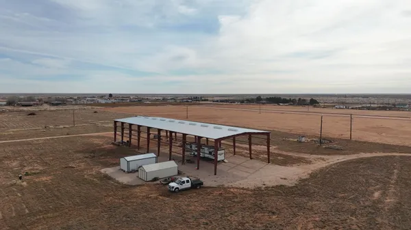 a view of a terrace with lawn chairs
