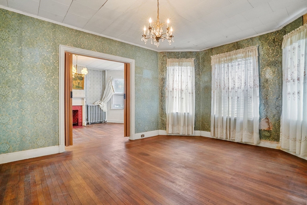 1 Copley Street Boston, MA 02119 - Photo 14 of 29 an empty room with wooden floor and windows