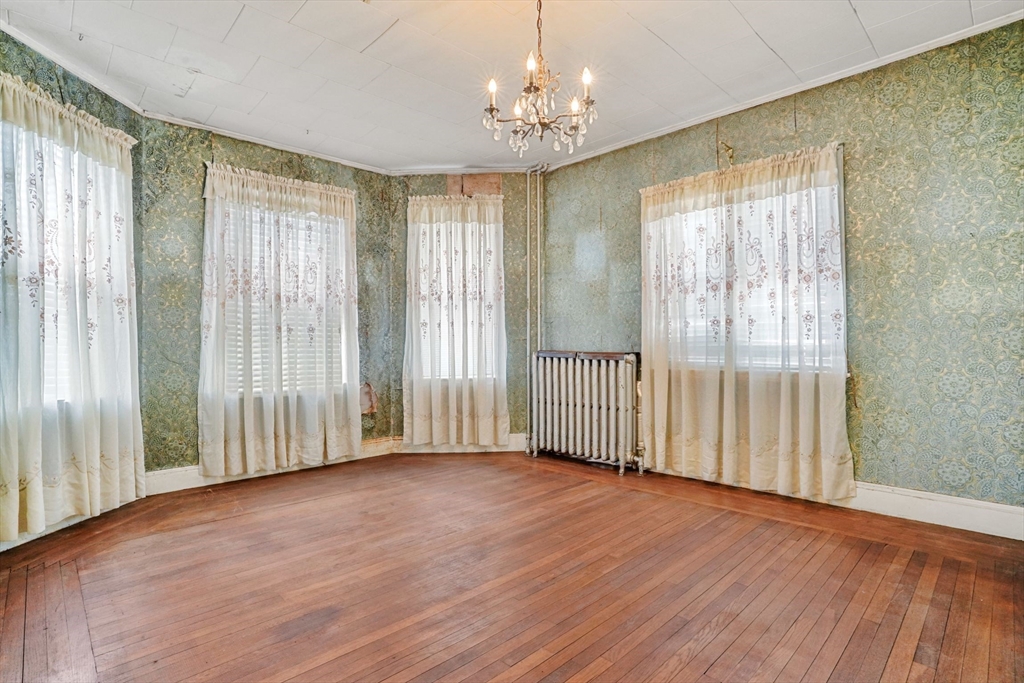 1 Copley Street Boston, MA 02119 - Photo 15 of 29 an empty room with wooden floor and windows