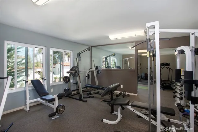 a view of a livingroom with workspace and a window
