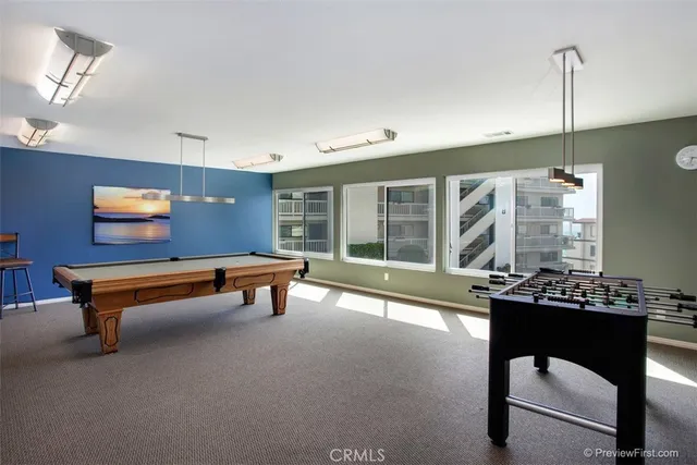 a living room with a table chairs and a window
