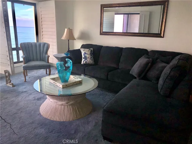 a living room with furniture and a lamp