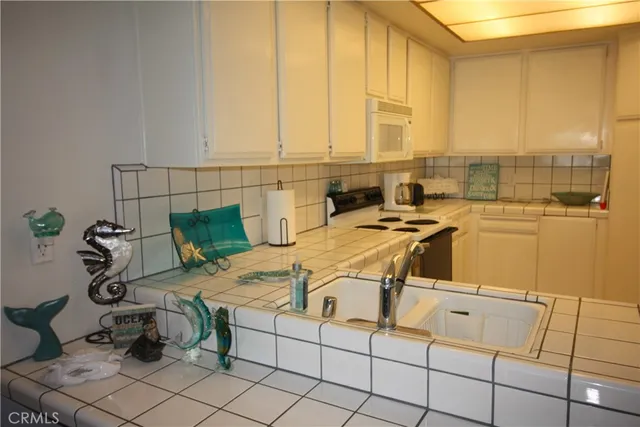 a table with chairs and white cabinets