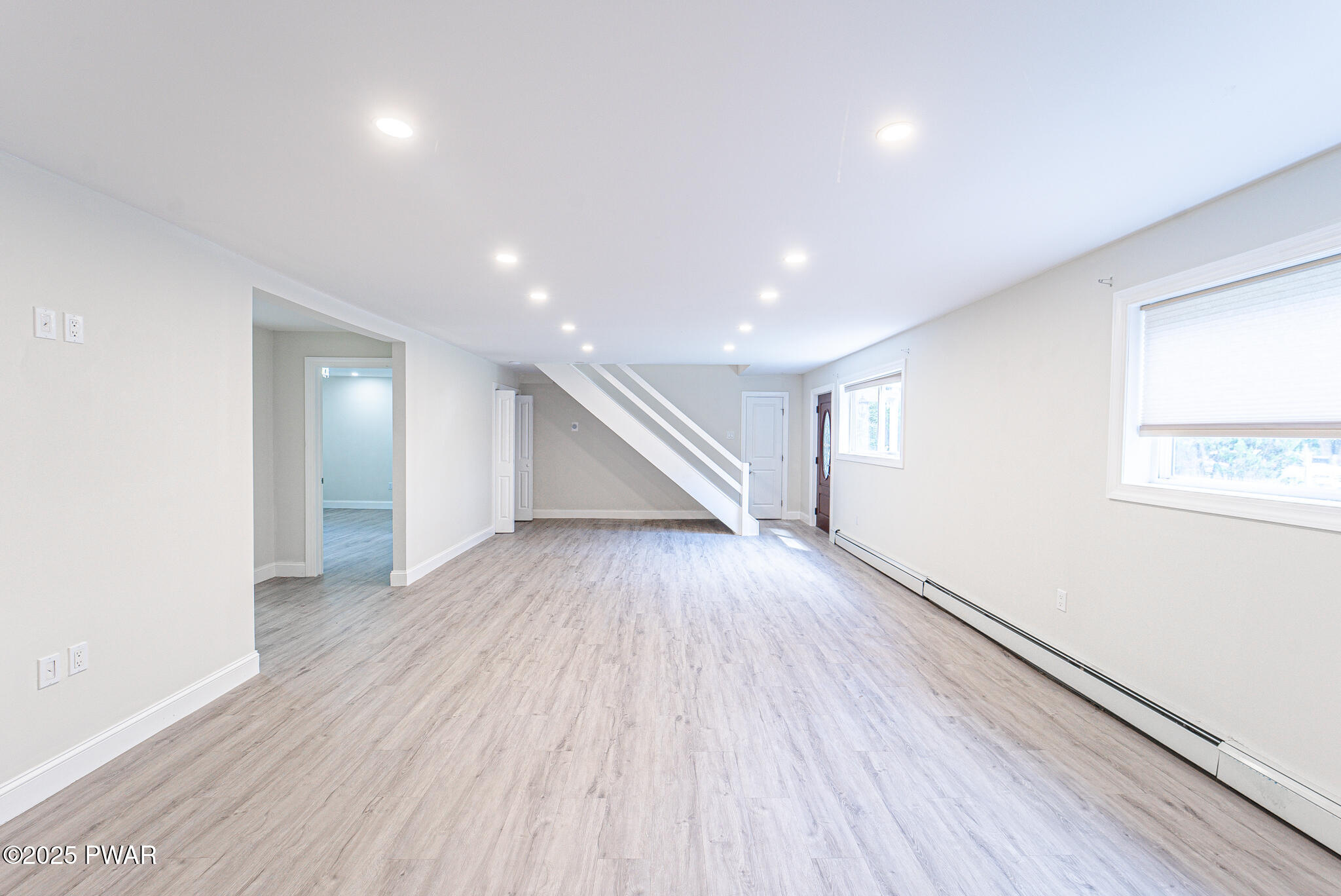 153 Hatton Road Hawley, PA 18428 - Photo 23 of 38 an empty room with wooden floor and windows
