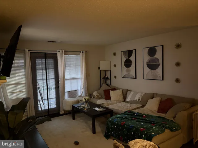 a living room with furniture and large window