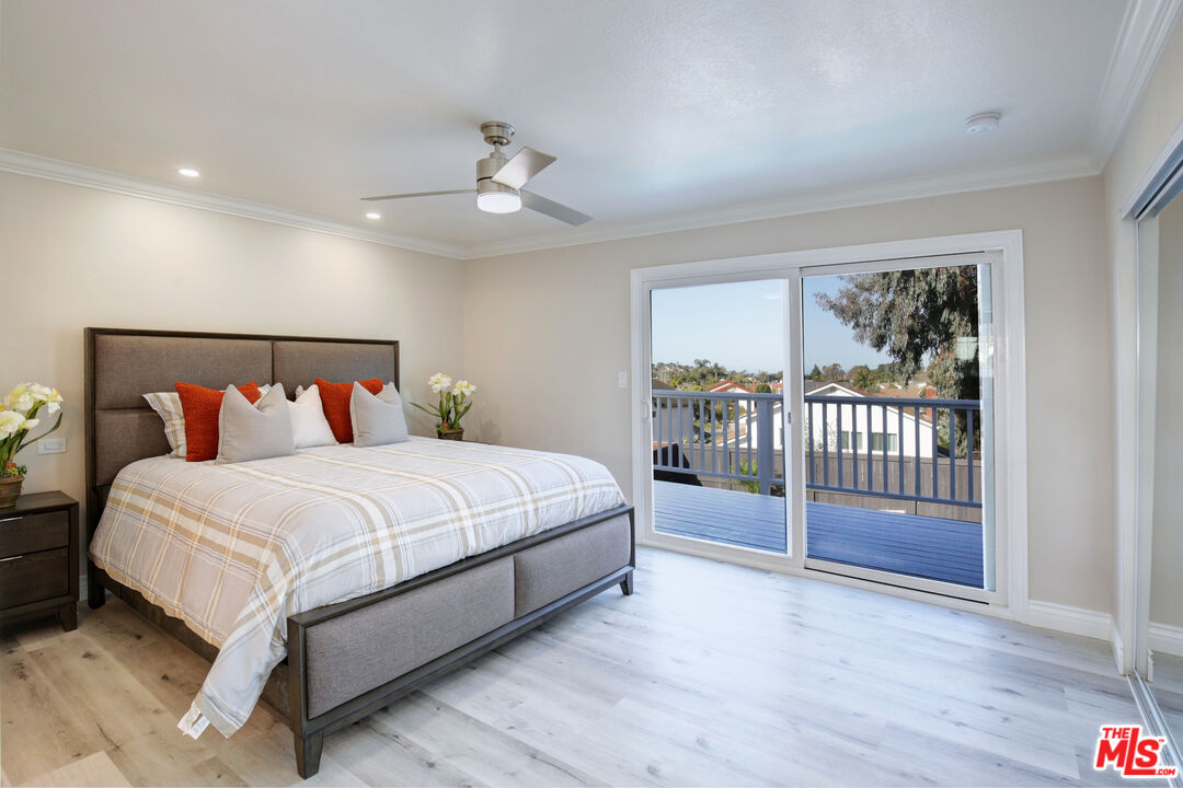 33051 Daniel Drive Dana Point, CA 92629 - Photo 11 of 30 a bedroom with a balcony a bed and a chandelier