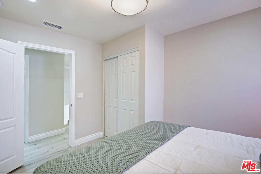 33051 Daniel Drive Dana Point, CA 92629 - Photo 19 of 30 a bedroom with a bed and cabinets