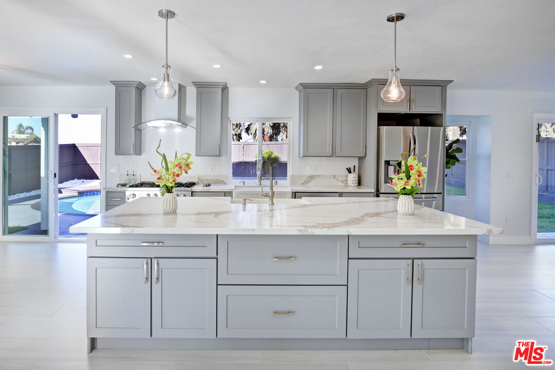 33051 Daniel Drive Dana Point, CA 92629 - Photo 4 of 30 a kitchen with kitchen island granite countertop a sink and a refrigerator