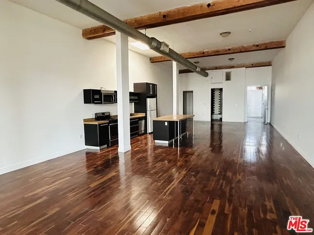 a view of kitchen with furniture and wooden floor