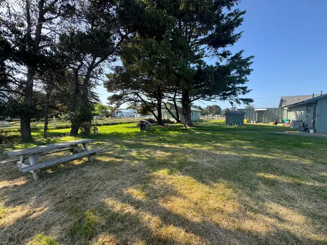 a view of yard with swimming pool and trees