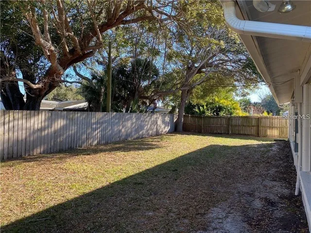 a kitchen with stainless steel appliances granite countertop a sink a stove and a wooden floors