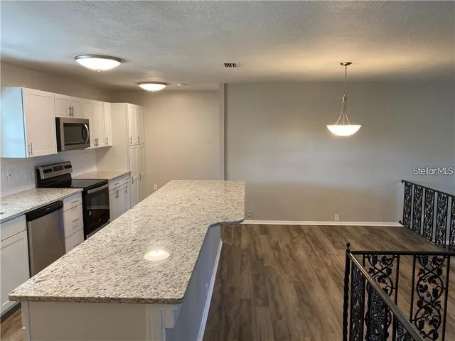a view of kitchen with wooden floor