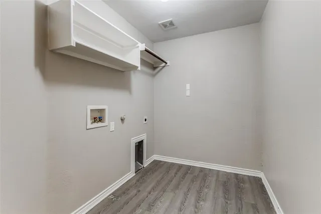 a view of storage and utility room with wooden floor