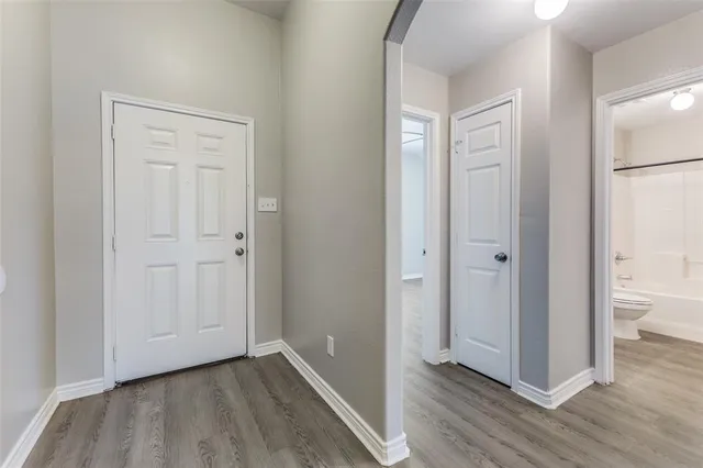 a view of a hallway with wooden floor