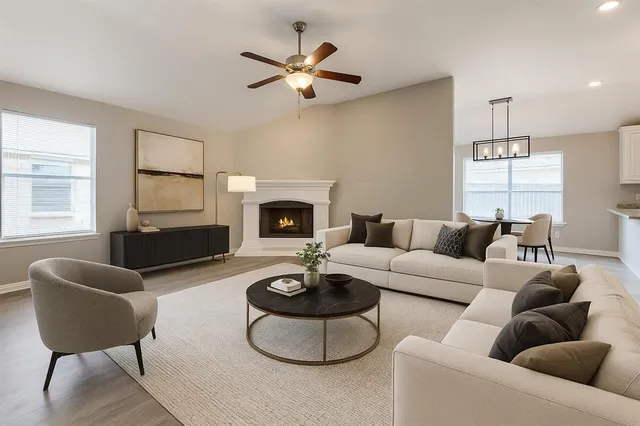 a living room with furniture a fireplace and a flat screen tv
