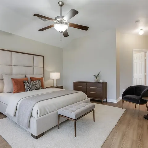 a bedroom with a bed and a lamp