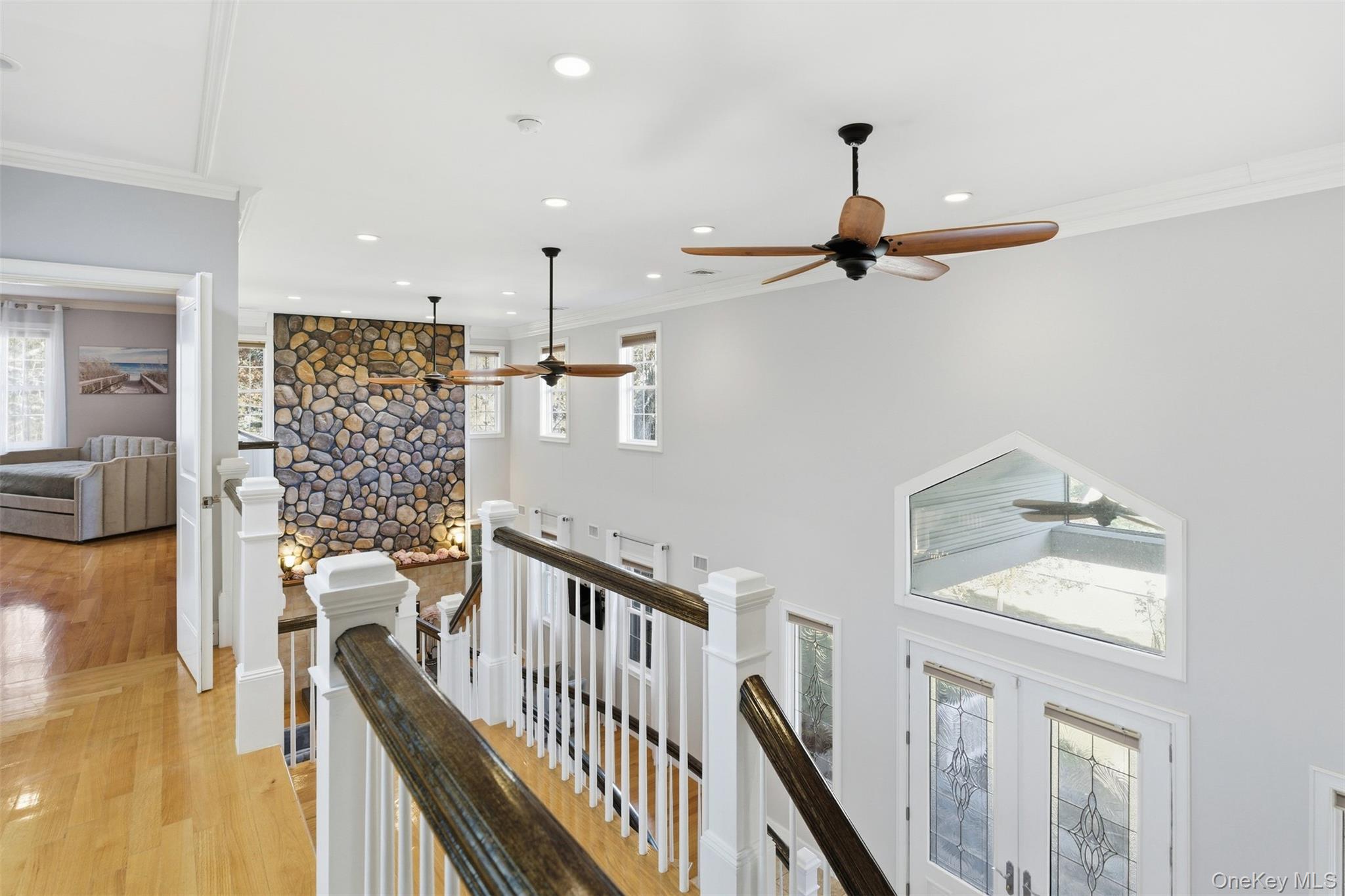 33 A Newtown Road Hampton Bays, NY 11946 - Photo 30 of 50 Hall with healthy amount of natural light, an upstairs landing, crown molding, recessed lighting, and light wood-style floors
