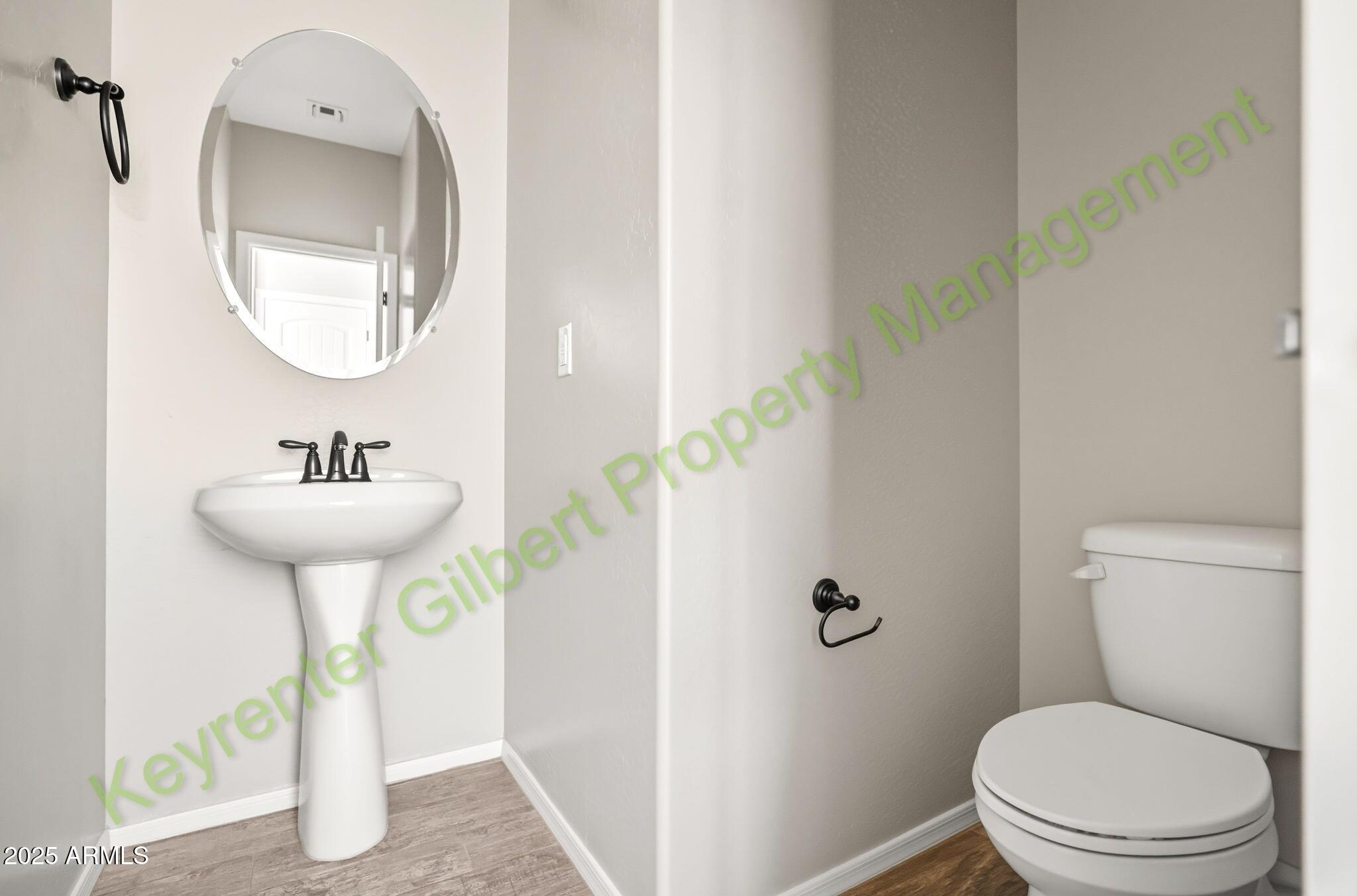 4761 East Portola Valley Drive, Unit 102 Gilbert, AZ 85297 - Photo 12 of 34 a bathroom with a toilet sink and mirror