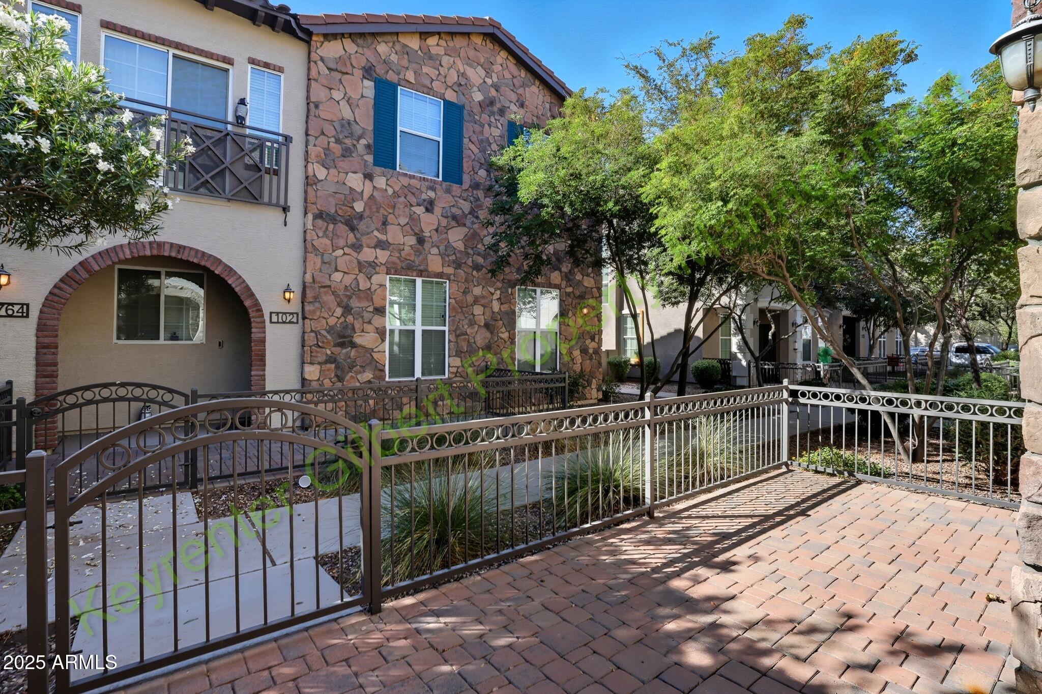 4761 East Portola Valley Drive, Unit 102 Gilbert, AZ 85297 - Photo 2 of 34 a view of house with outdoor space and trees