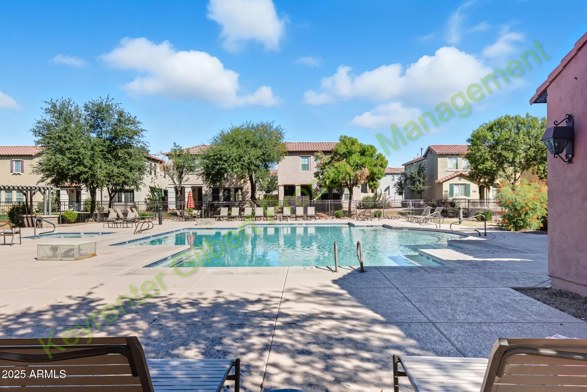4761 East Portola Valley Drive, Unit 102 Gilbert, AZ 85297 - Photo 26 of 34 a view of a yard with cars