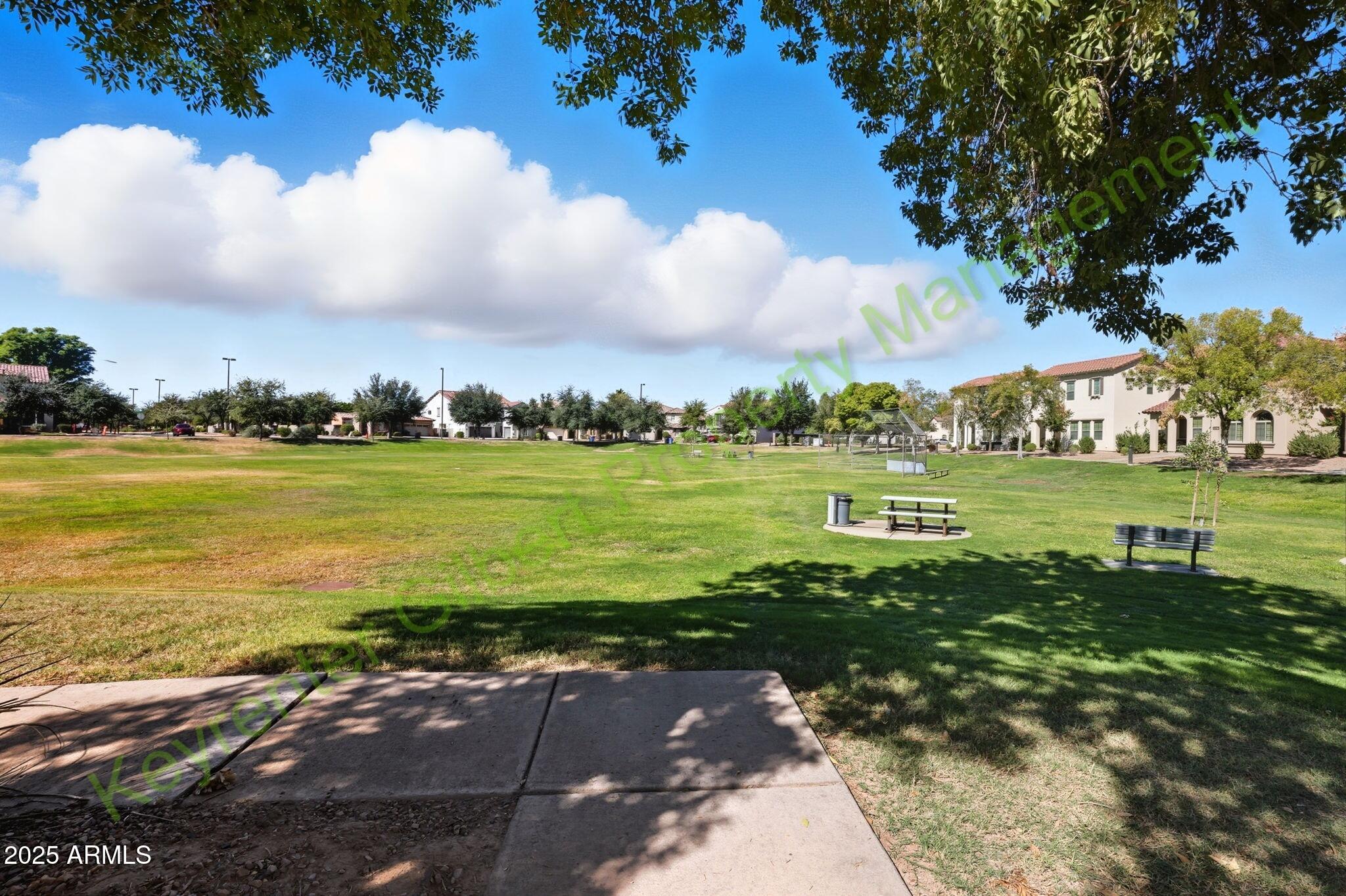 4761 East Portola Valley Drive, Unit 102 Gilbert, AZ 85297 - Photo 27 of 34 a view of a lake with houses in the back