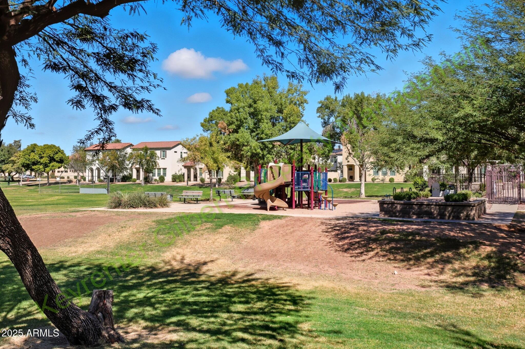 4761 East Portola Valley Drive, Unit 102 Gilbert, AZ 85297 - Photo 28 of 34 a view of a park with swings and slides