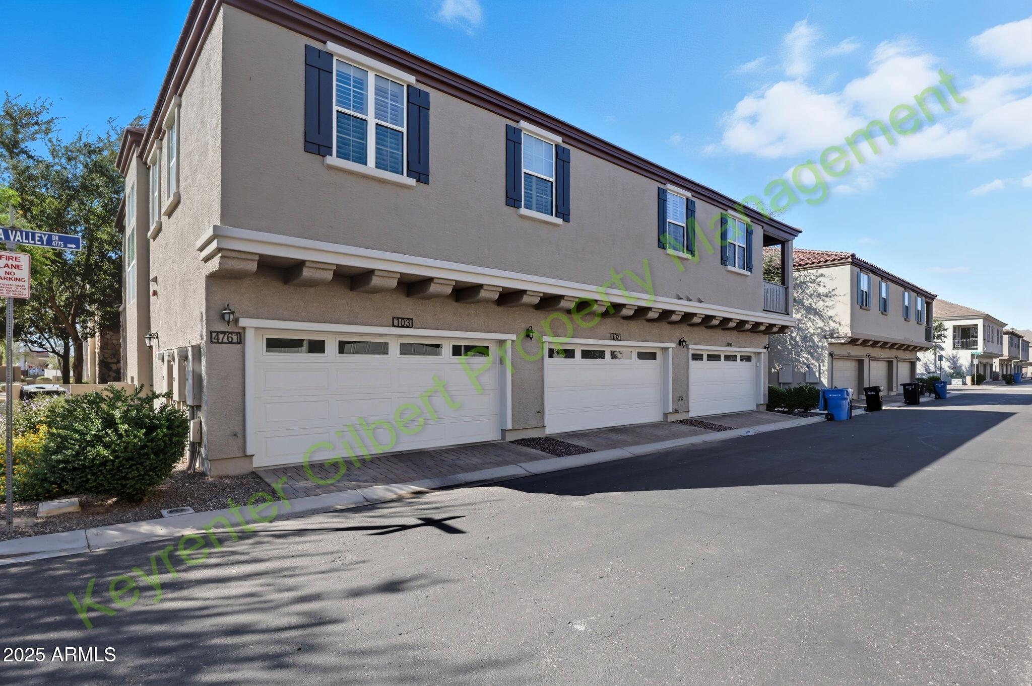 4761 East Portola Valley Drive, Unit 102 Gilbert, AZ 85297 - Photo 4 of 34 a front view of a house with a yard