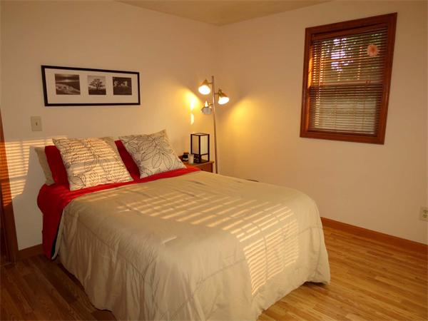 5 Houghton Road Sutton, MA 01590 - Photo 18 of 26 a bedroom with a bed and a chandelier