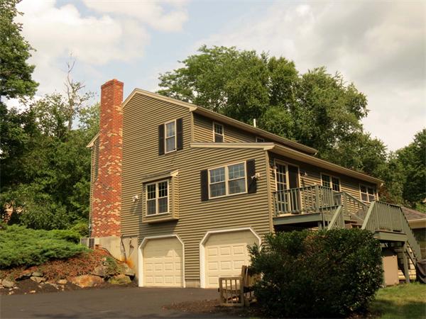 5 Houghton Road Sutton, MA 01590 - Photo 22 of 26 a front view of a house with a garden