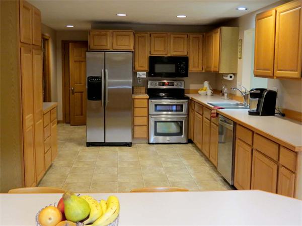 5 Houghton Road Sutton, MA 01590 - Photo 8 of 26 a kitchen with stainless steel appliances granite countertop a refrigerator a stove top oven a sink and dishwasher