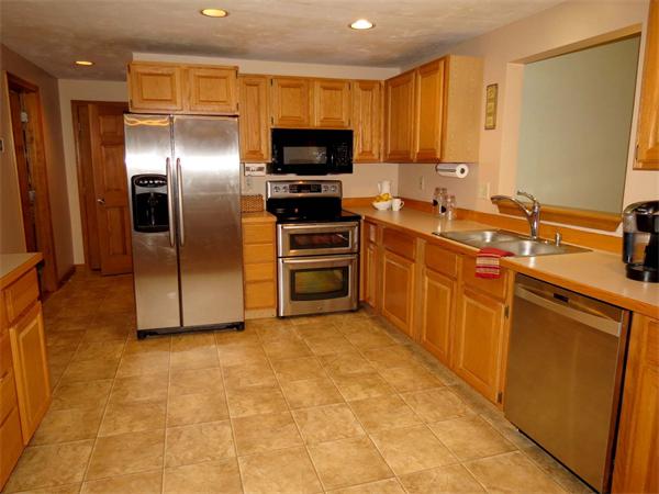5 Houghton Road Sutton, MA 01590 - Photo 9 of 26 a kitchen with stainless steel appliances granite countertop a stove a sink and a refrigerator