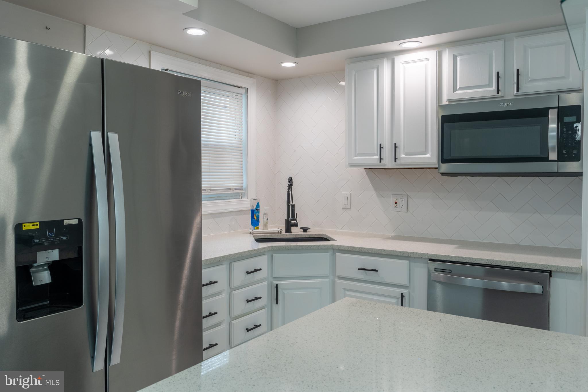 12675 Biscayne Drive Philadelphia, PA 19154 - Photo 13 of 50 a kitchen with stainless steel appliances white cabinets and a refrigerator