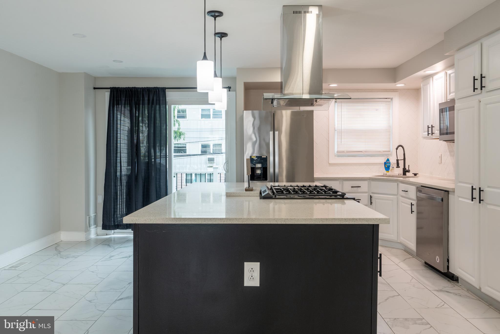 12675 Biscayne Drive Philadelphia, PA 19154 - Photo 16 of 50 a kitchen with kitchen island a sink appliances and cabinets