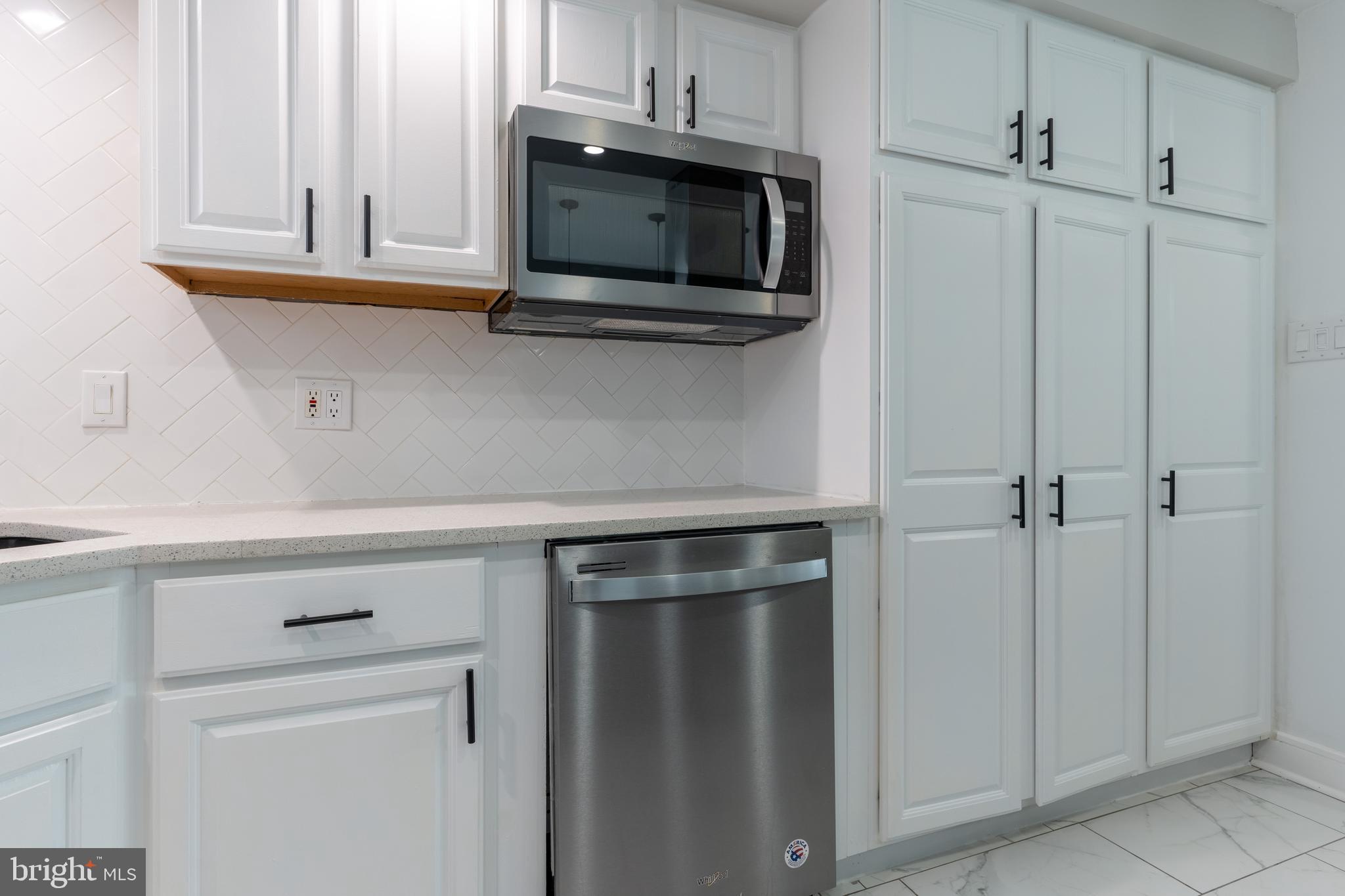 12675 Biscayne Drive Philadelphia, PA 19154 - Photo 17 of 50 a kitchen with stainless steel appliances white cabinets and a microwave oven