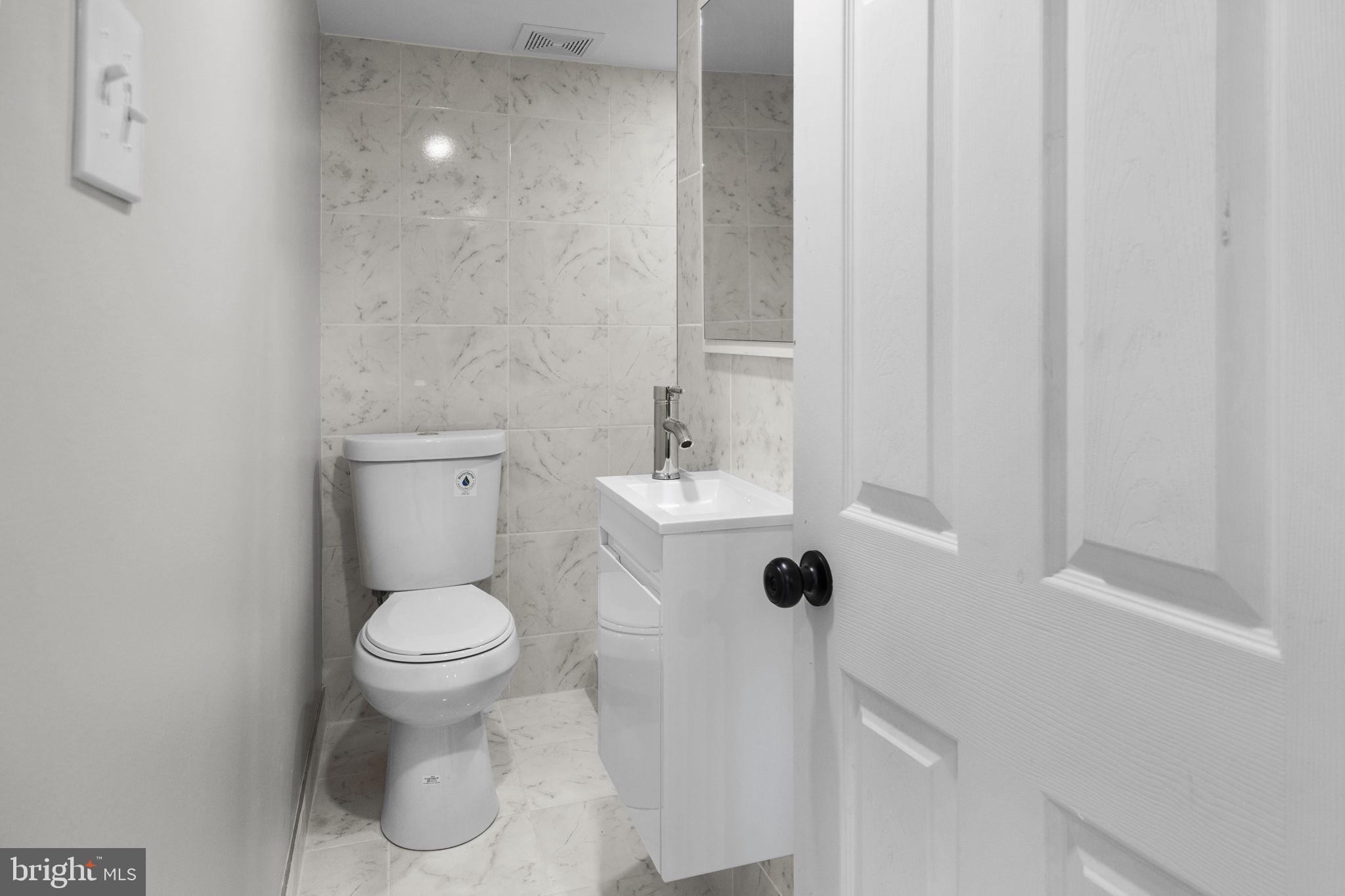 12675 Biscayne Drive Philadelphia, PA 19154 - Photo 47 of 50 a bathroom with a sink a toilet and a mirror
