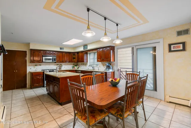 a kitchen with stainless steel appliances granite countertop a stove refrigerator and a sink