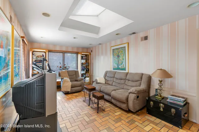 a bedroom with a bed and a couch with window