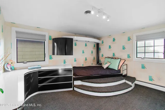 a spacious bedroom with a bed and window