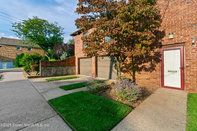a front view of a house with a yard and street