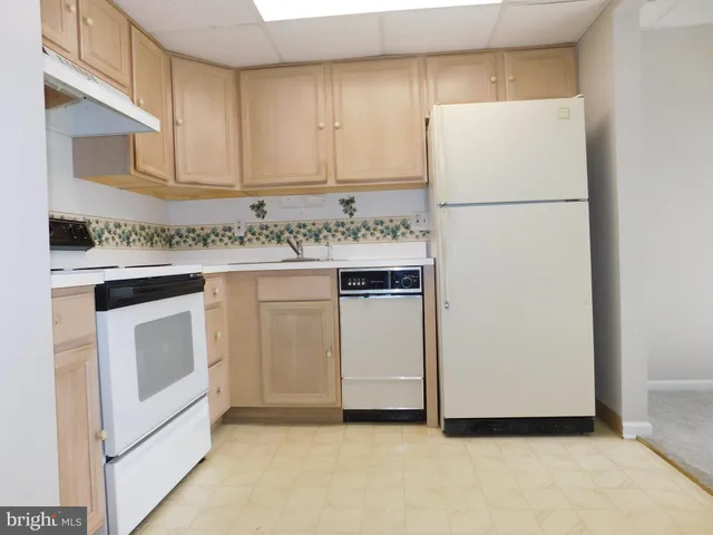 a white refrigerator freezer sitting inside of a kitchen