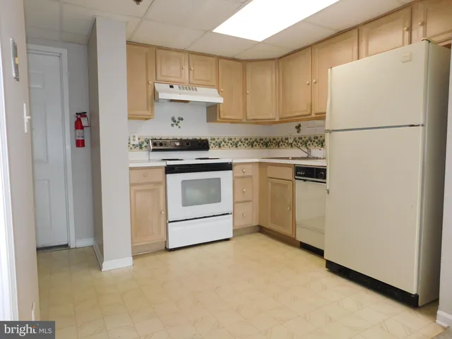 a kitchen with a stove top oven sink and refrigerator