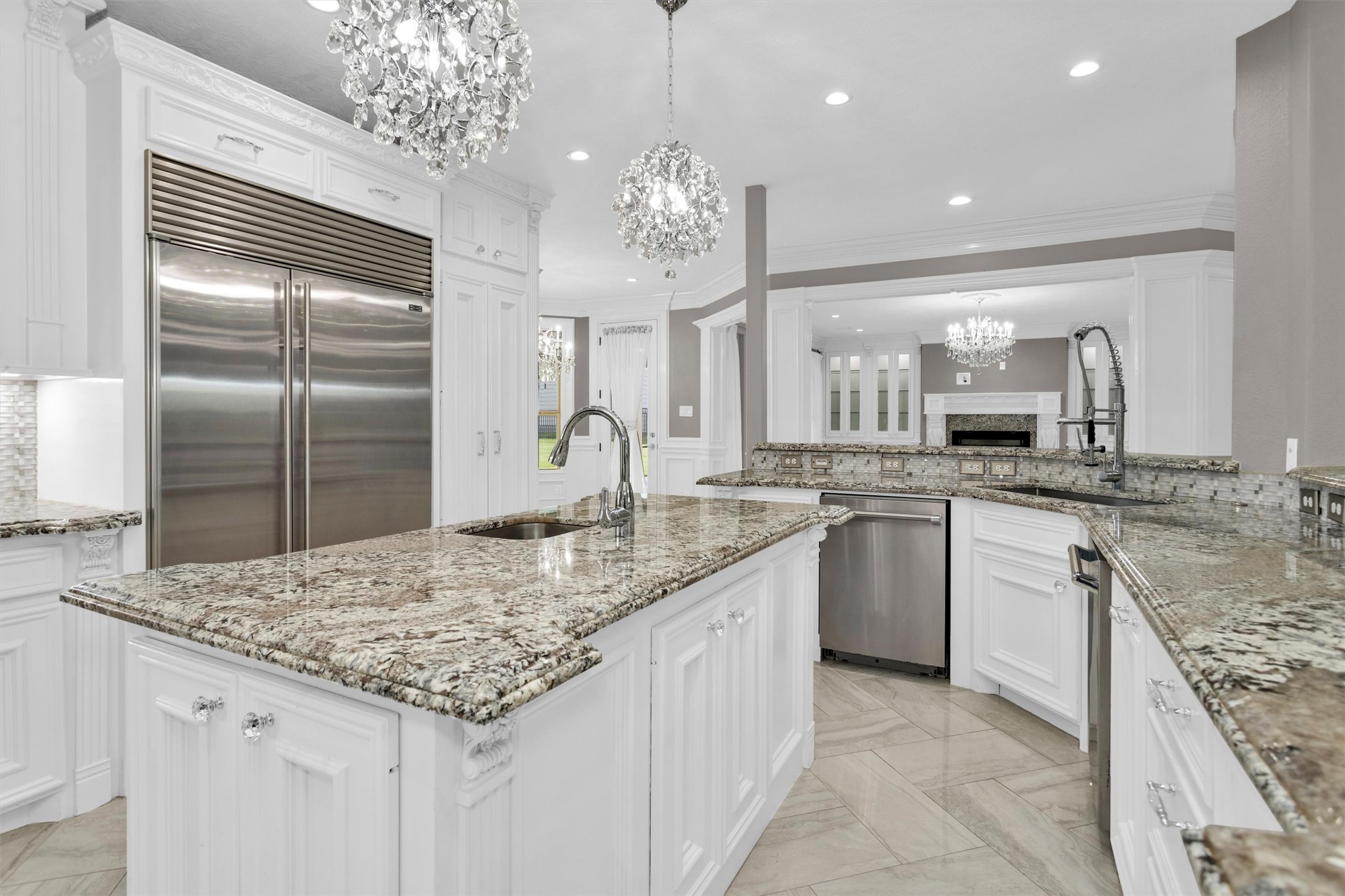 10887 Decatur Street Willis, TX 77318 - Photo 18 of 50 Oversized pendant lighting over the island adds a high-end focal point while tying the space together and keeping it bright and inviting.