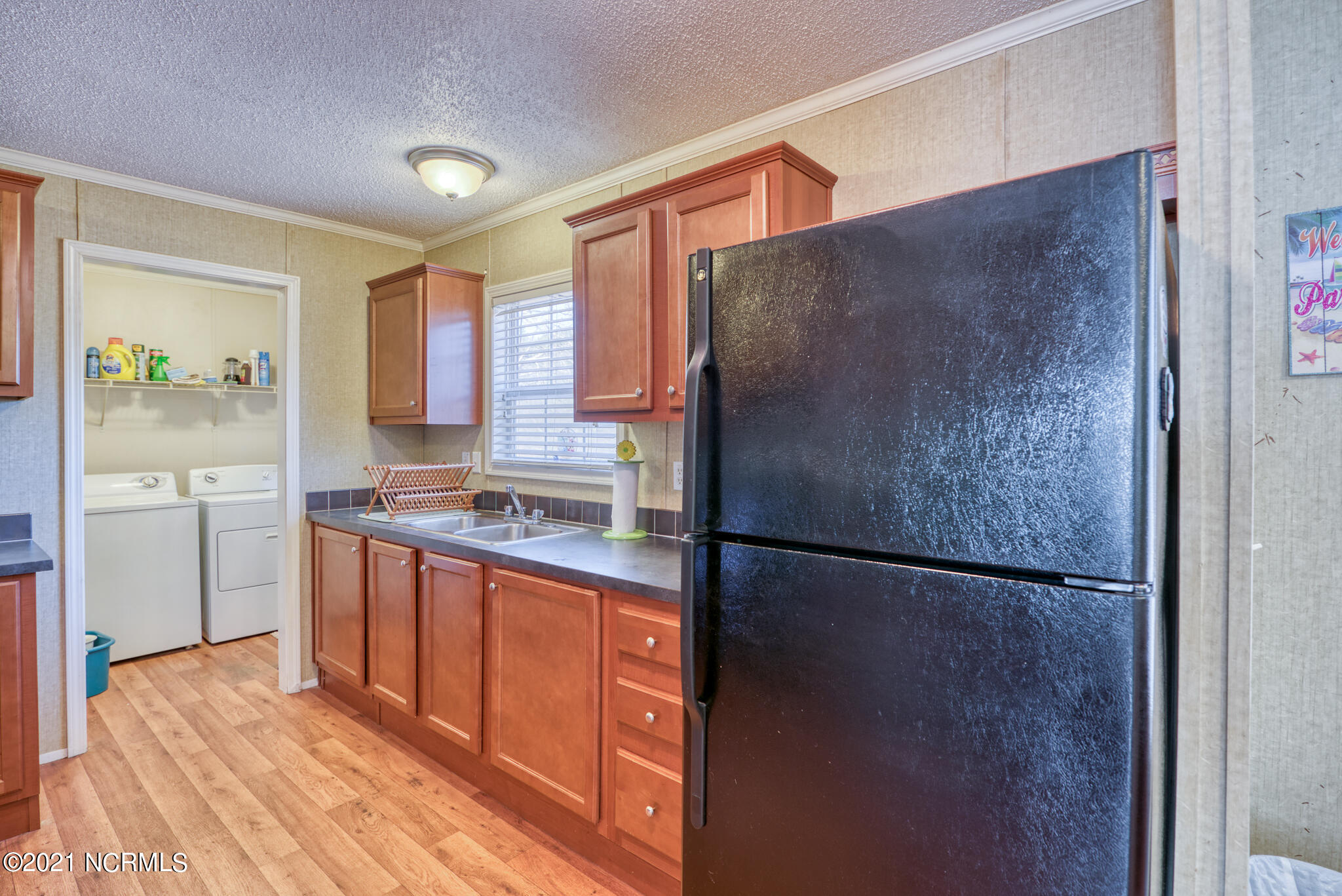 60 Gerainium Road Hampstead, NC 28443 - Photo 15 of 31 Kitchen Cabinets and Laundry Room