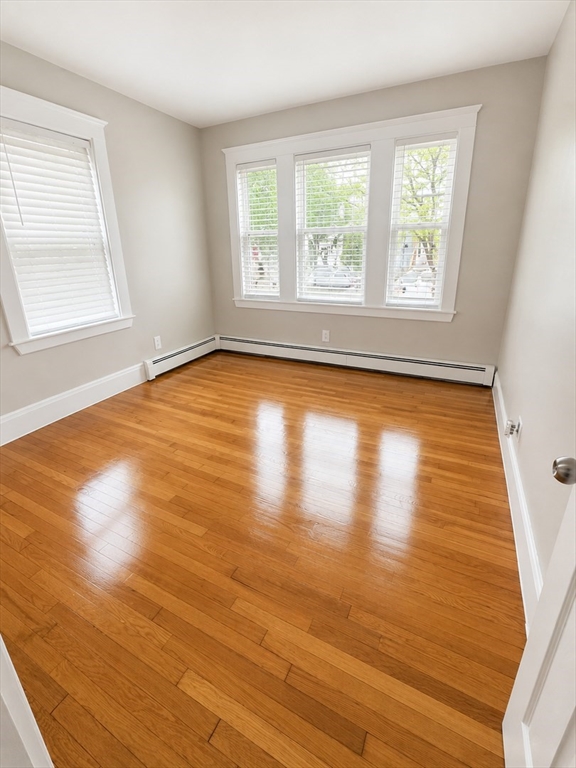 196 Washington Street, Unit 2 Lynn, MA 01902 - Photo 3 of 4 a view of empty room with wooden floor and fan